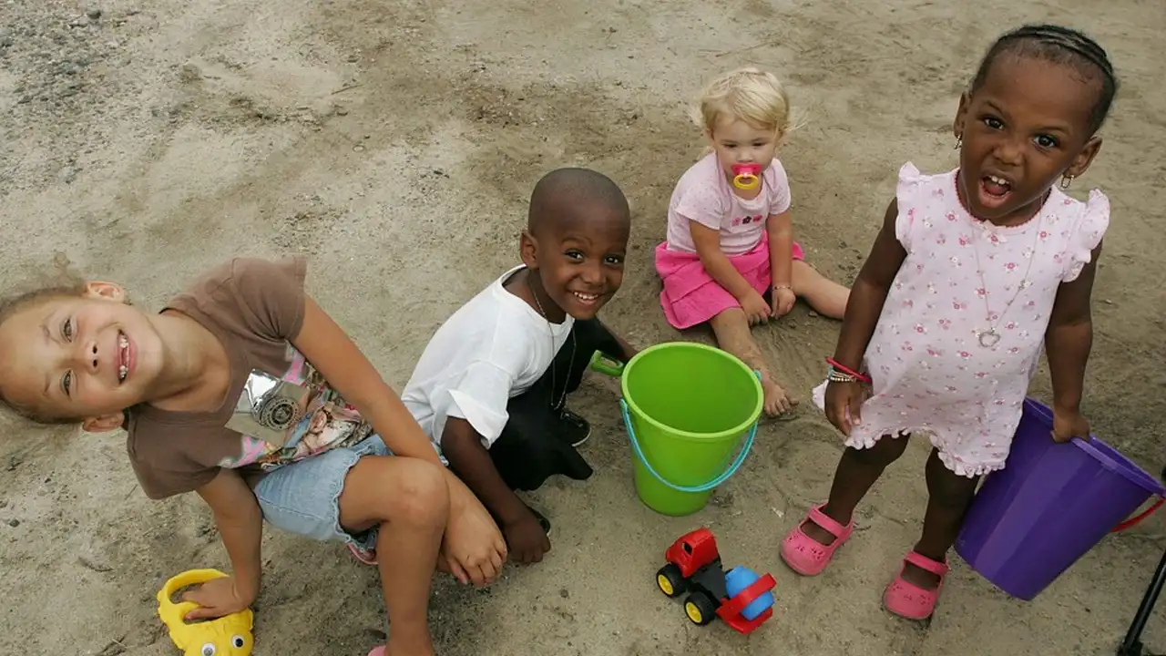 Close up on a plate of mashed potatoes, topped with baked pork chops with cream of mushroom soup, and a side of green beans.