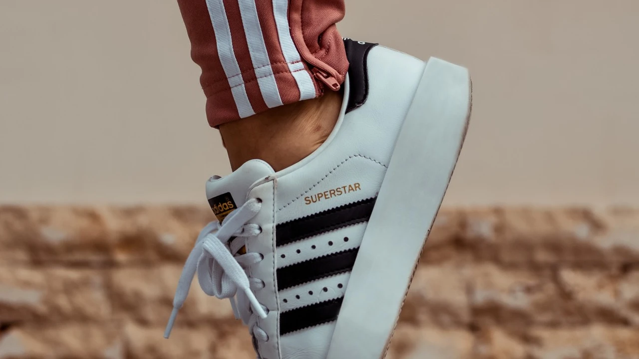 Close up on a plate of mashed potatoes, topped with baked pork chops with cream of mushroom soup, and a side of green beans.