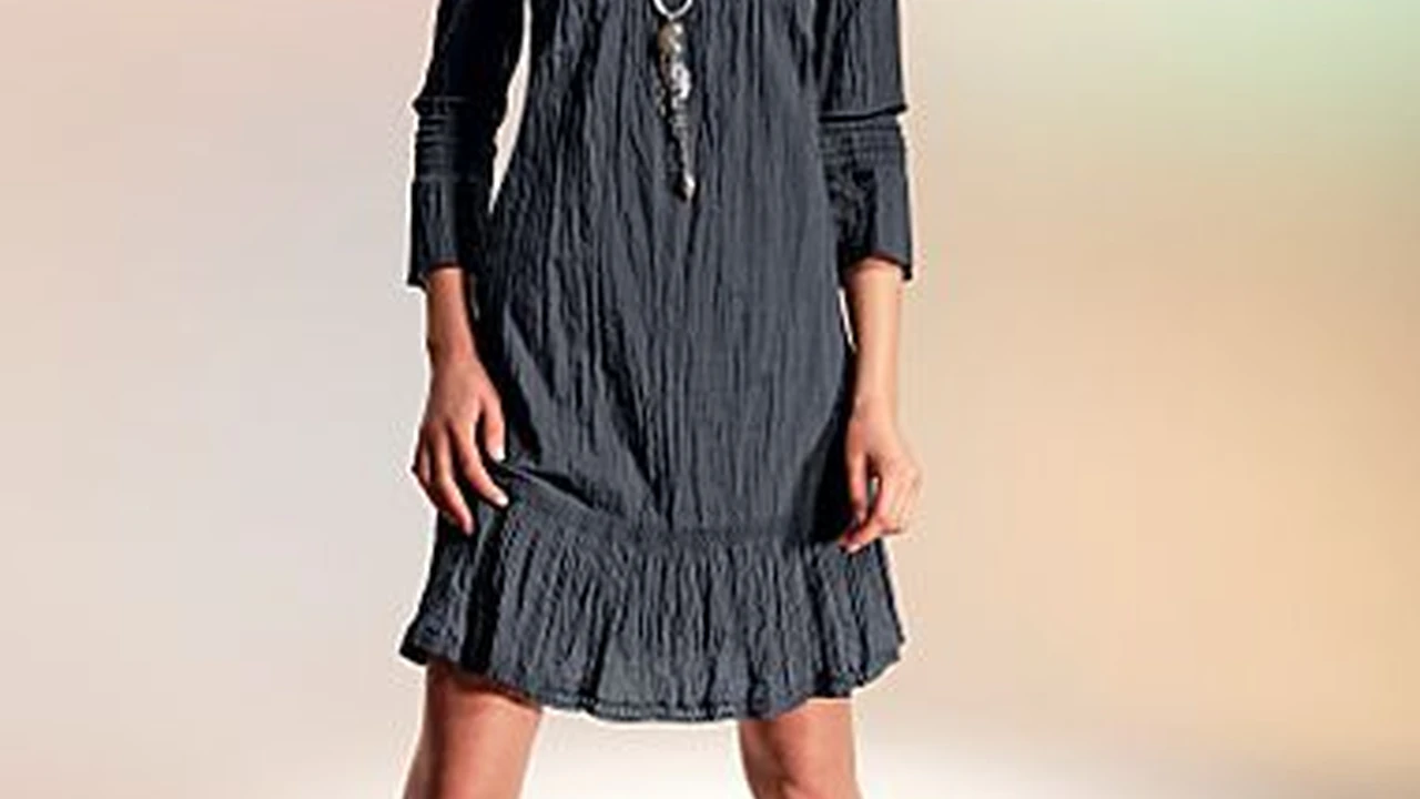 Close up on a plate of mashed potatoes, topped with baked pork chops with cream of mushroom soup, and a side of green beans.